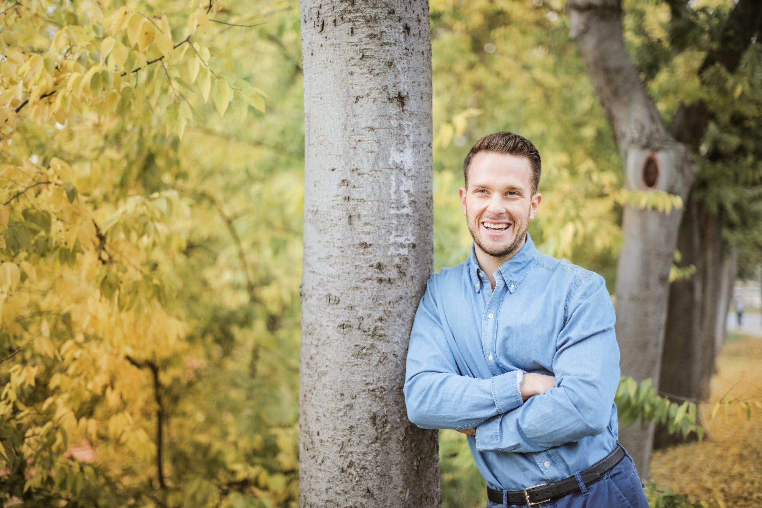 A man leaning against a tree, ready to have an honest conversation