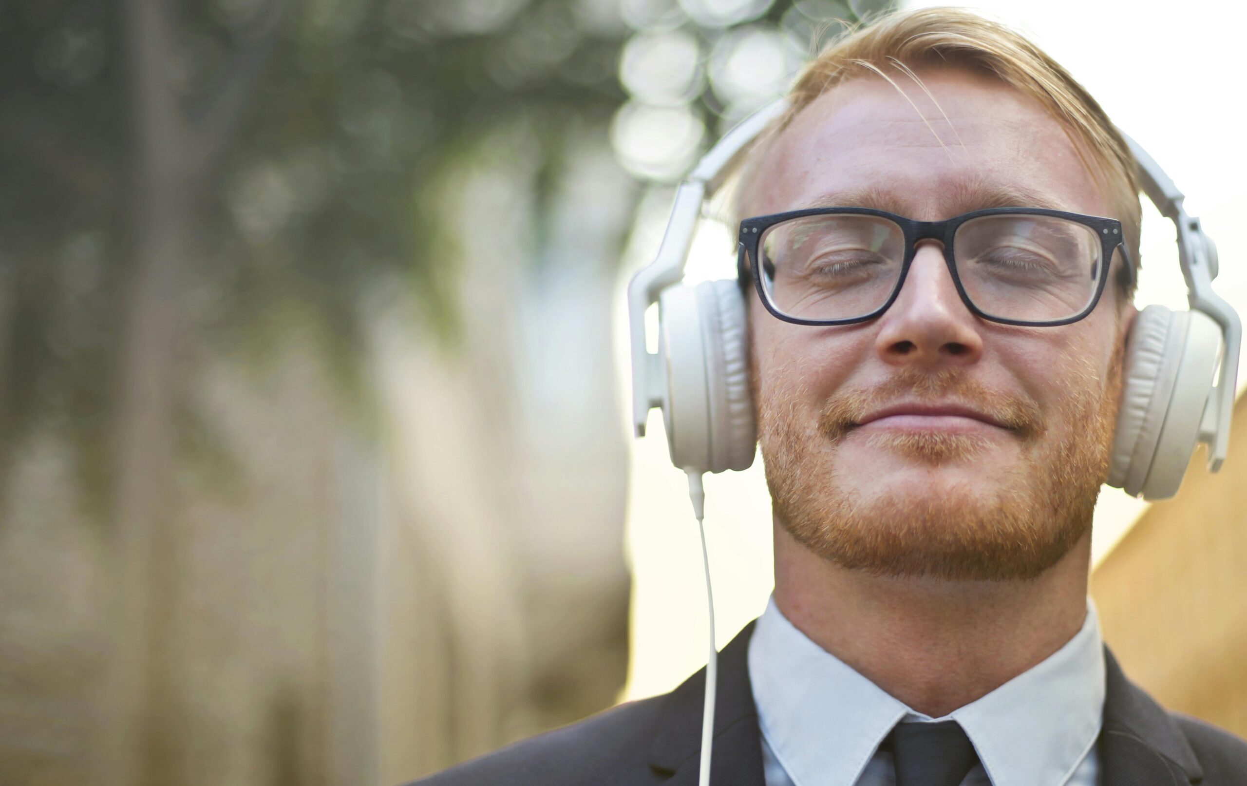 A man with headphones and glasses, calm and focused — peace of mind from clear legal services
