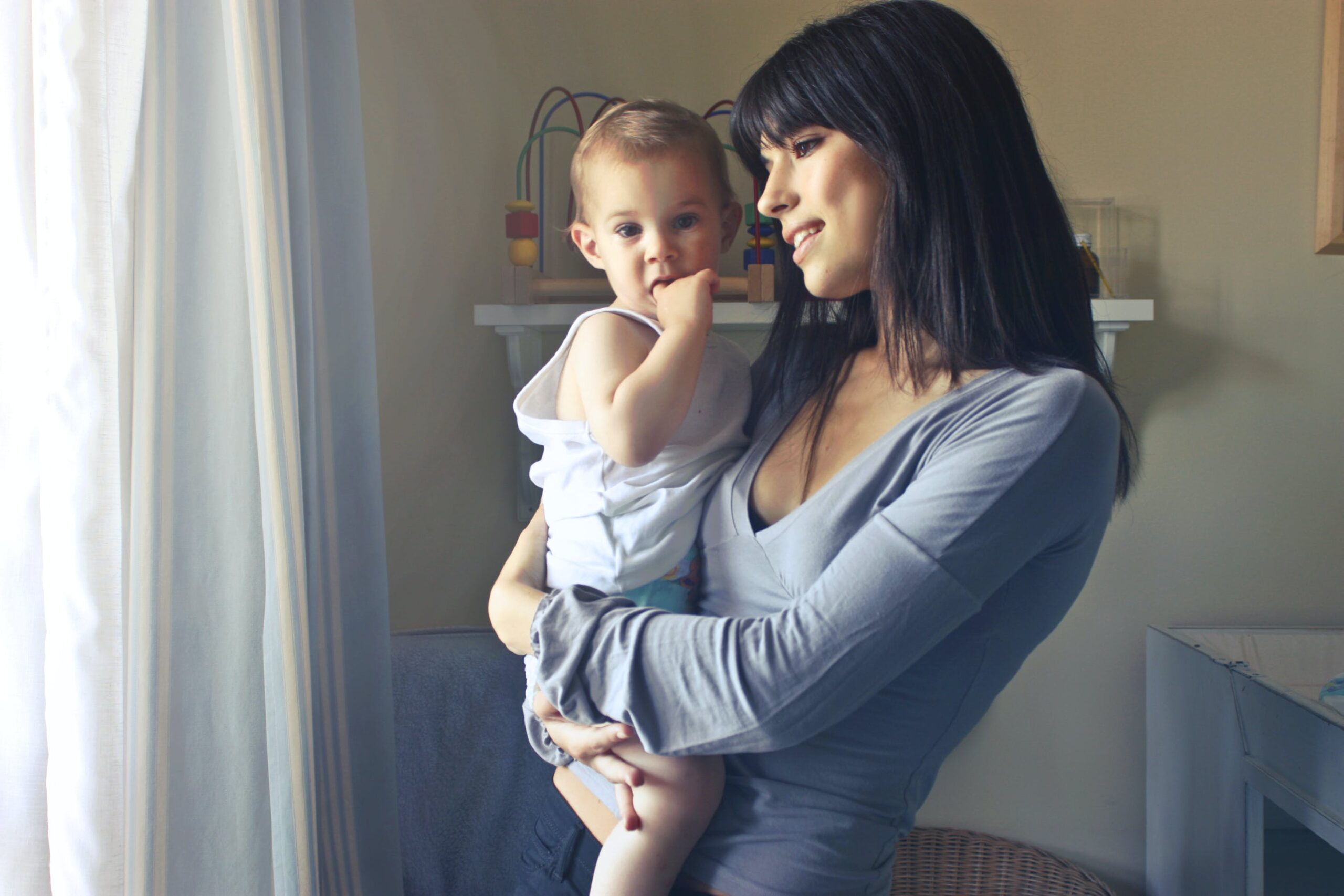 A parent holding a baby at home — family life after marriage